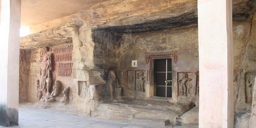 An image view of the Udayagiri Caves showcasing intricate rock-cut sculptures and lush surroundings.
