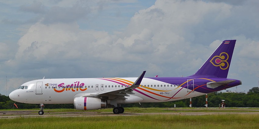 A stunning view of an aeroplane standing on a runway at Udon Thani International Airport.