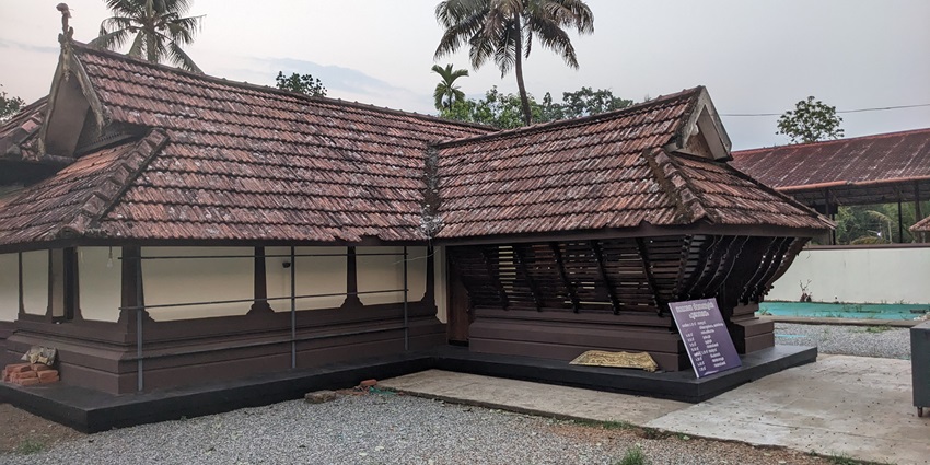 A picture of a traditional temple’s courtyard with the backside of the temple visible in background