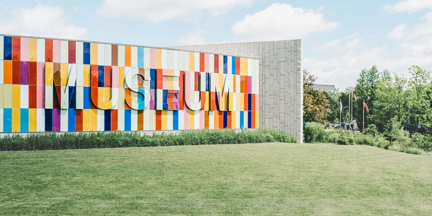 Image of a museum architecture view from the outside on an open field and clean surroundings