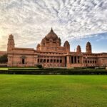 Interior view of a museum room inside Umaid Bhawan Palace, featuring large wooden display