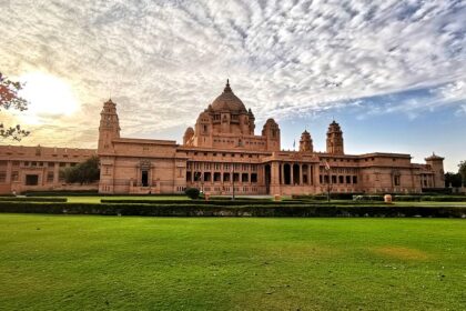 Interior view of a museum room inside Umaid Bhawan Palace, featuring large wooden display