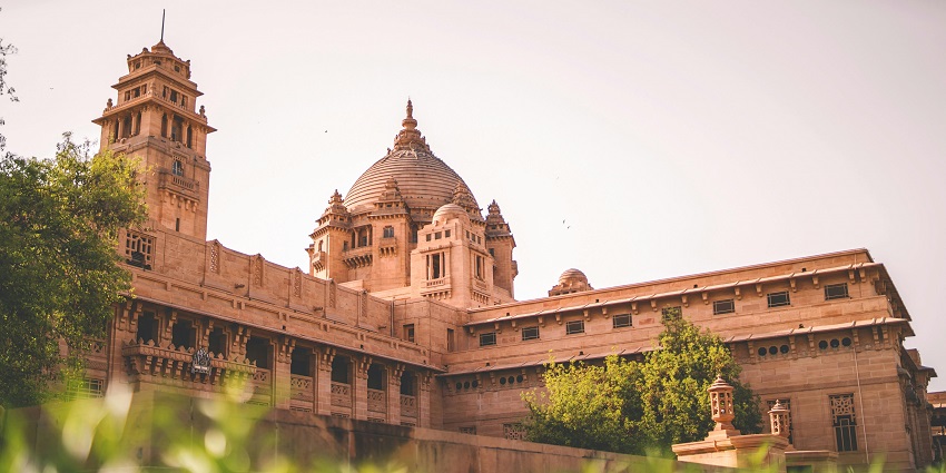 Umaid Bhawan Palace, one of the places to visit in Jodhpur, framed by lush palace garden views.