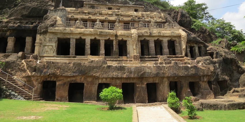 A cave system with multiple entrances and greenery nearby. One of the best places to visit near Vijayawada
