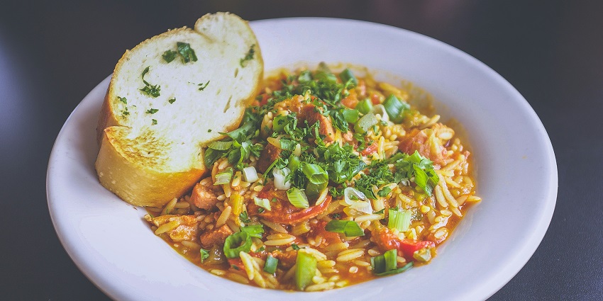 A glimpse of Undhiyu served in plate with bread and garnished with coriander leaves.