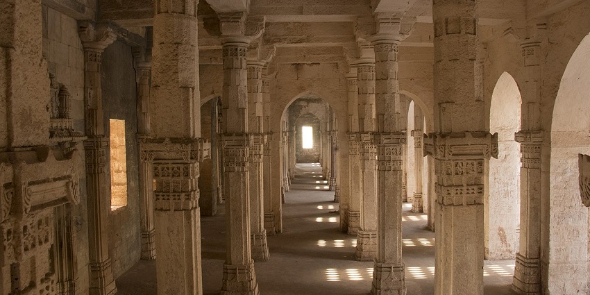 A picture taken at a historical building showing the pillars inside it