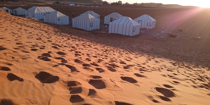 Utsav Desert Camp is filled with eco-tents, camel safaris, Rajasthani cuisine, and cultural activities