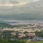 A bird’s eye view capturing the lush rolling hills decked with houses in Maharashtra.