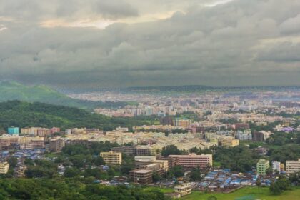 A bird’s eye view capturing the lush rolling hills decked with houses in Maharashtra.