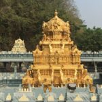 A picture of a temple with a golden building in the middle surrounded with the temple structure