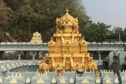 A picture of a temple with a golden building in the middle surrounded with the temple structure