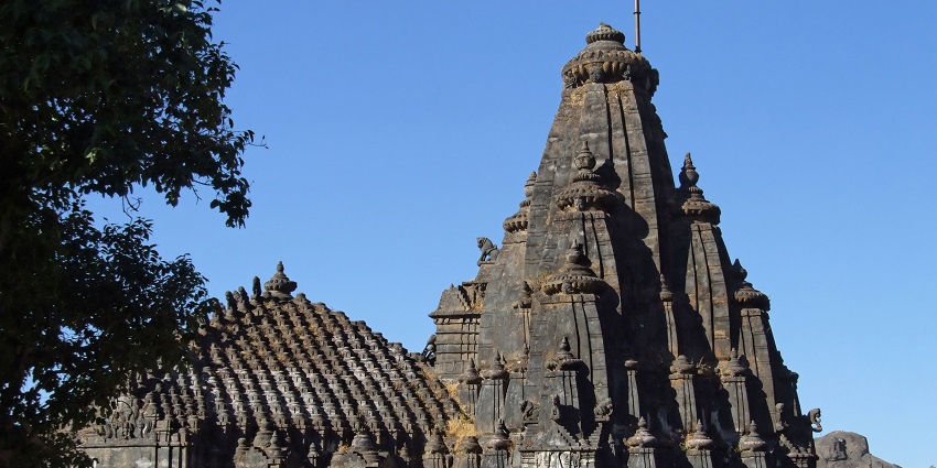 Tall black stone building of the Vimal shah temple, one of the best places for devotees to visit