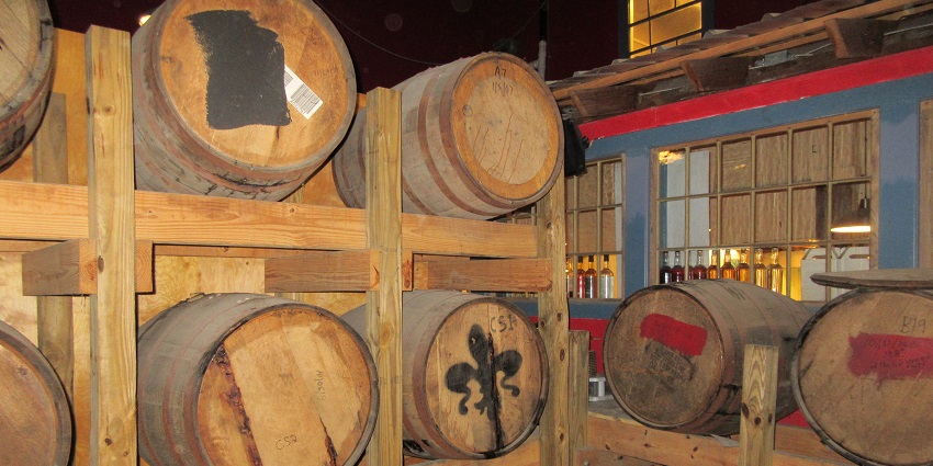 Different types of rum being prepared in various barrels at a Rum Distillery