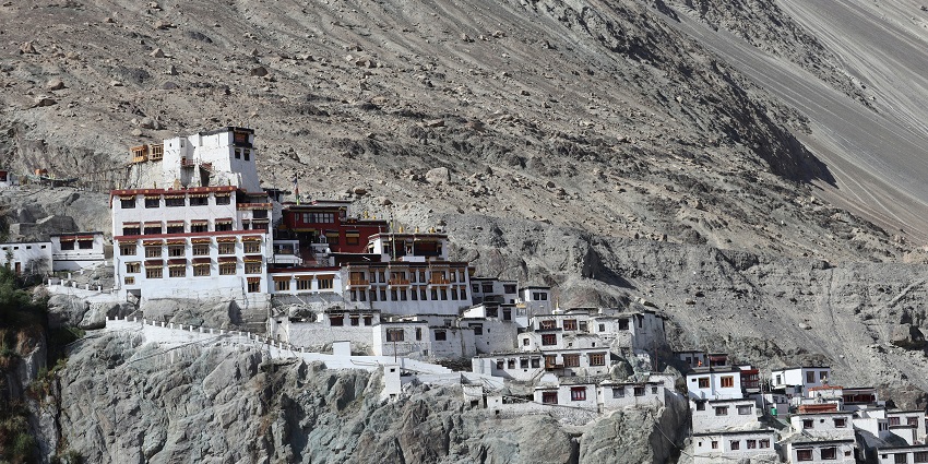 Picturesque view of Diskit Monastery on top of the hill with rocks and under blue sky