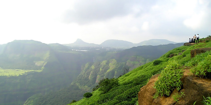 Waterfall cascading down a rocky, mountainous terrain with steep slopes near Lonavala.