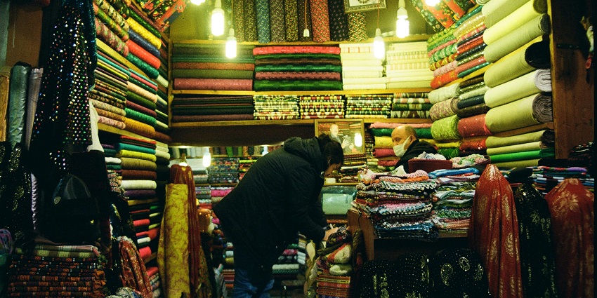 An image scene in Sagar's local market, showcasing colourful stalls filled with handicrafts and textiles.