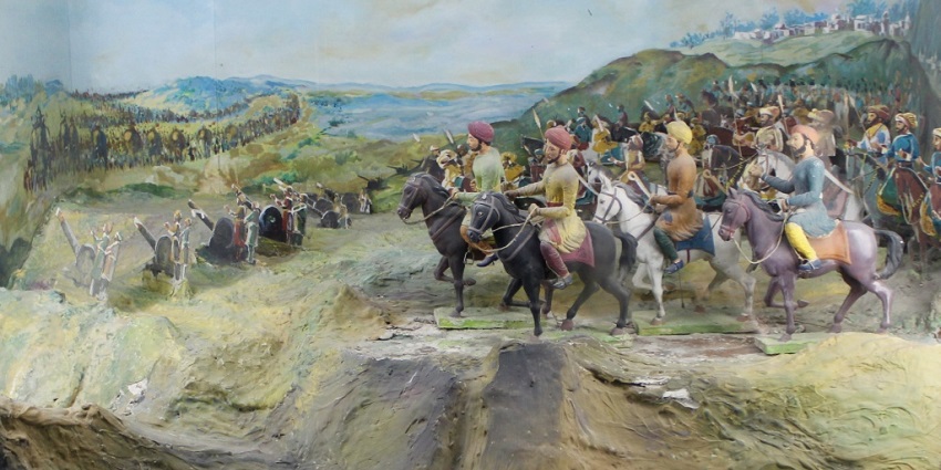 An inside view of the museum of the region featuring painting showcasing iconic battles.