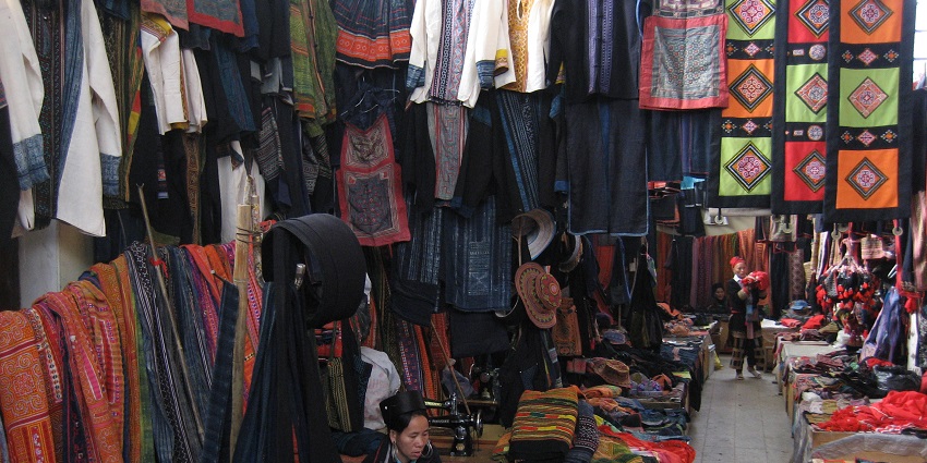 Vibrant Sapa market bustling with local vendors and tourists displaying traditional goods in Vietnam