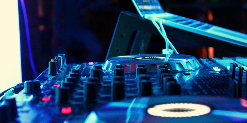 An image of a DJ at a party, illustrating a vibrant nightlife scene akin to Bhutan nightlife.