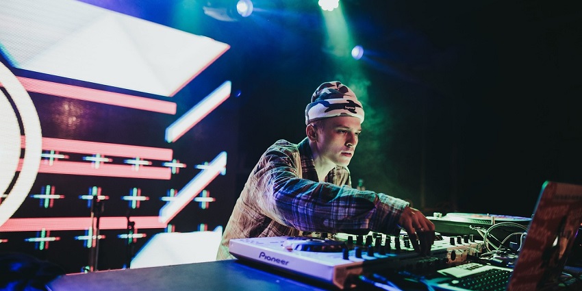 An image of a DJ at a party, illustrating a vibrant nightlife scene akin to Bhutanese events.