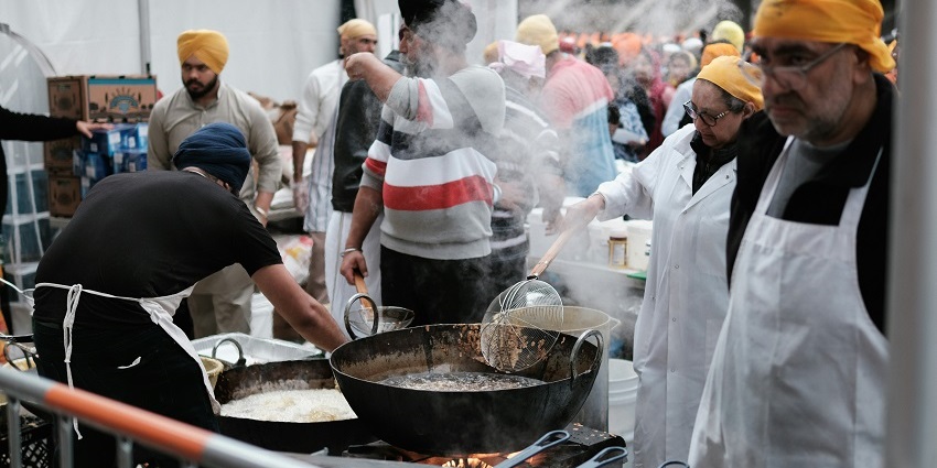 Snapshot of a group of people working voluntarily in the community Kitchen called Langar sewa in Golden Temple