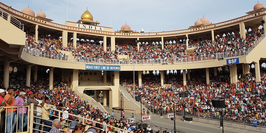 An image of the Wagah Border ceremony, showcasing the energetic atmosphere of the flag-lowering ceremony.