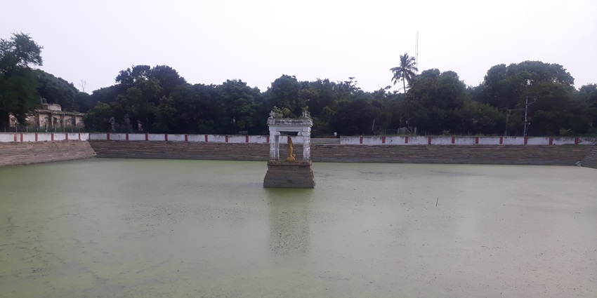 Panoramic image of the pond in the premises of the temple amidst the green lush trees