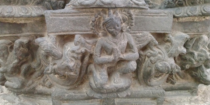 A picture of an intricate carving with human figures drawn, kept at display in a museum