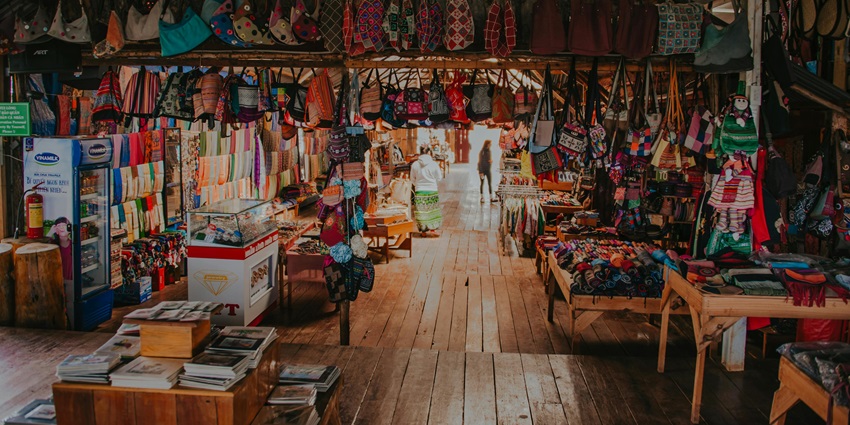 Image of Garage Sale - a market where bags are hanging and handicraft items for sale