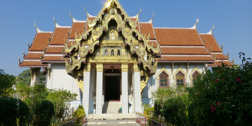 Picturesque view of the monastery entrance, with intricate carvings sparkling under the sun