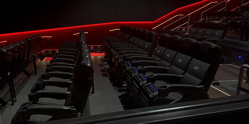 A 4D theatre with stylish black leather seats adorned with sharp red and yellow lights.
