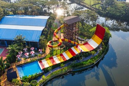 An aerial view of a leisure hub decked with colourful slides and sprawling pools.