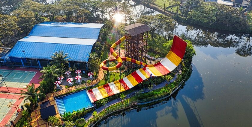 An aerial view of a leisure hub decked with colourful slides and sprawling pools.