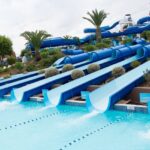 A bunch of water slides at a water park to seek thrill and a fun day full of adventure.