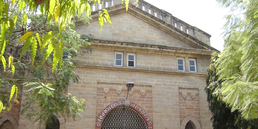 Entryway of Watson Museum featuring arched doorways, stone pillars, and historical charm.