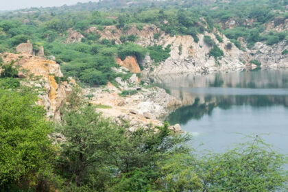 A picture of a lake surrounded by small hills and greenery