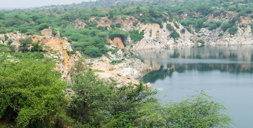 A picture of a lake surrounded by small hills and greenery