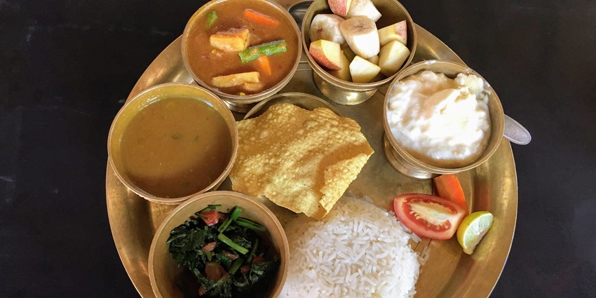 Nepali dal-bhat-tarkari, a traditional meal, enjoyed by visitors near Patan Museum.