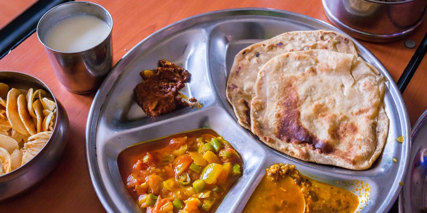 Delicious assortment of cooked dishes served on a round tray with vibrant colors
