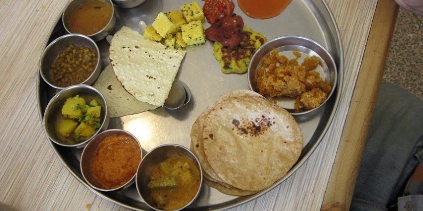 The thali offers many Gujarati dishes.