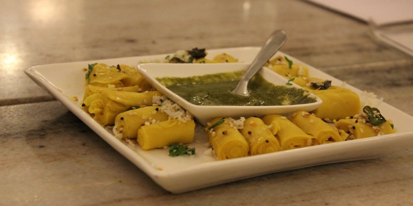 Authentic Gujarati dish, Khandavi, served with mint chutney at a restaurant nearby