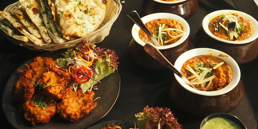A picture of a full-fledged north Indian meal served on a table at a restaurant near Hauz Khas Fort
