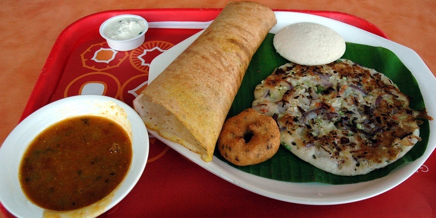 Dosa, uttapam and vada served with sambhar curry at a restaurant nearby
