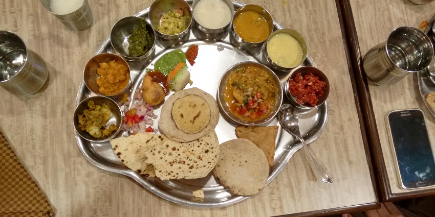 Traditional Madhya Pradesh thali, offering a taste of local cuisine served nearby