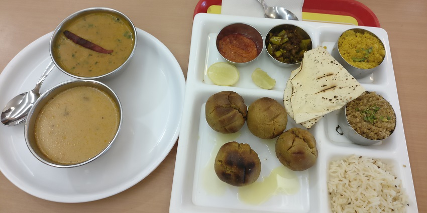 Churana Dal Bati served on a plate, highlighting a traditional dish near Tapovan Temple.
