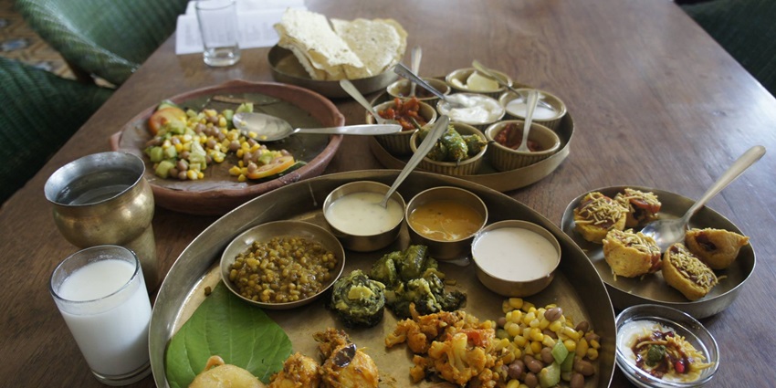 A vibrant Gujarati thali with diverse dishes, served near Rotary Dolls Museum Rajkot.