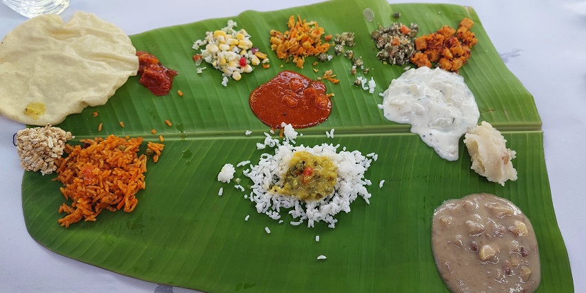 The traditional meal is served on the banana leaf with different varieties of Food