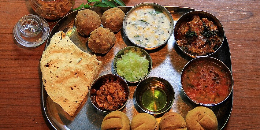 Traditional dal baati churma, a flavorful Rajasthani dish, enjoyed near Achalgarh Fort.