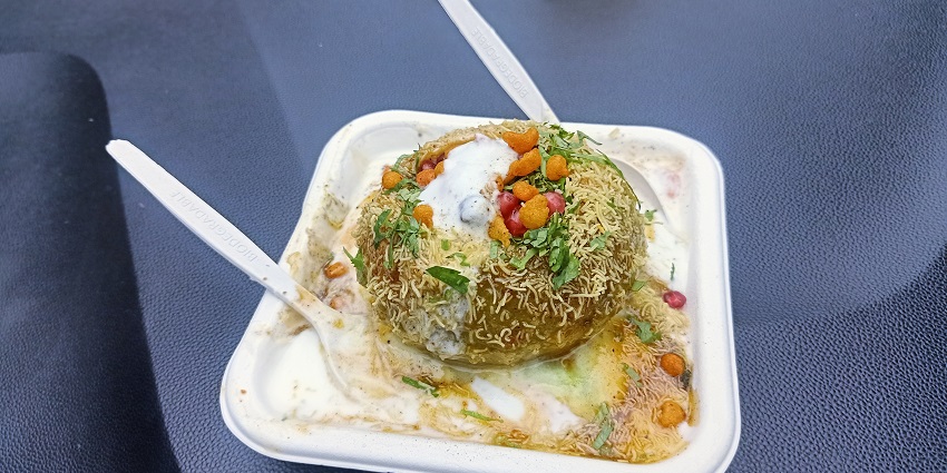 Close-up of a Raj Kachori dish in Bhopal, filled with yoghourt, chutneys, and sev toppings