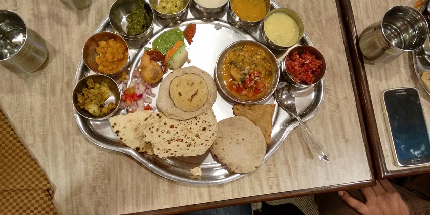 A vibrant Madhya Pradesh special thali showcasing an array of traditional Indian dishes-Bandhavgarh Wildlife Sanctuary
